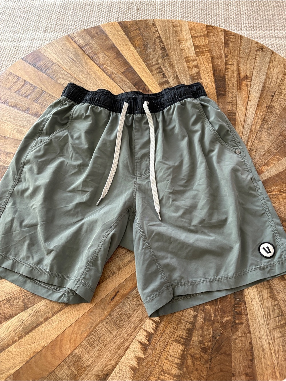 Vuori Olive Green Athletic Shorts with Black Waistband and White Drawstring